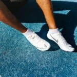 athlete running on track wearing sports shoes